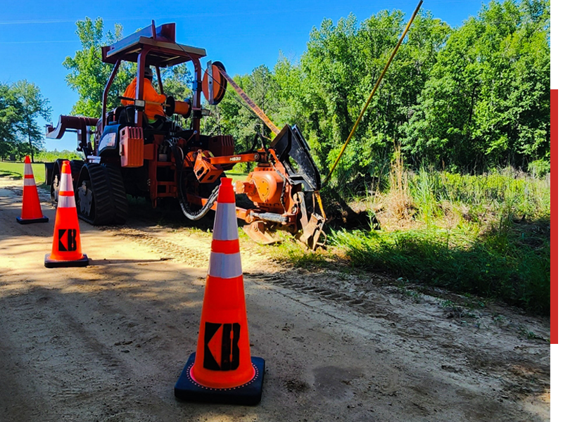 Construction worker operating backhoe loader in the field